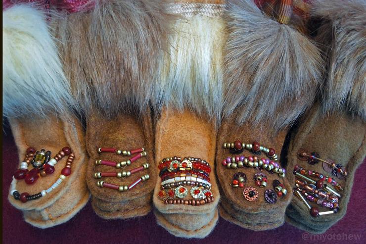 Five hand sewn boots with different beaded vamp designs. A red and gold theme with white and purple beads sewn in. Faux fur adds pizzazz and dramatic effect.