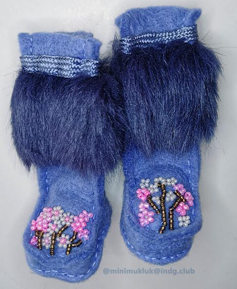 Miniature cherry blossom boots. Perfect for snugly winter feet.
Pink and white beads paired with metallic beads create cherry blossom shapes. Purple-ish blue felt with matching fur. The trim is made from shoelaces
