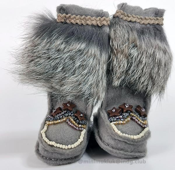 Star patterned felted miniature boots. Hand sewing with matching grey fur. Subtle ribbon completes the top edge. Each boot has brown stars em-blemished with sparkly beads.
