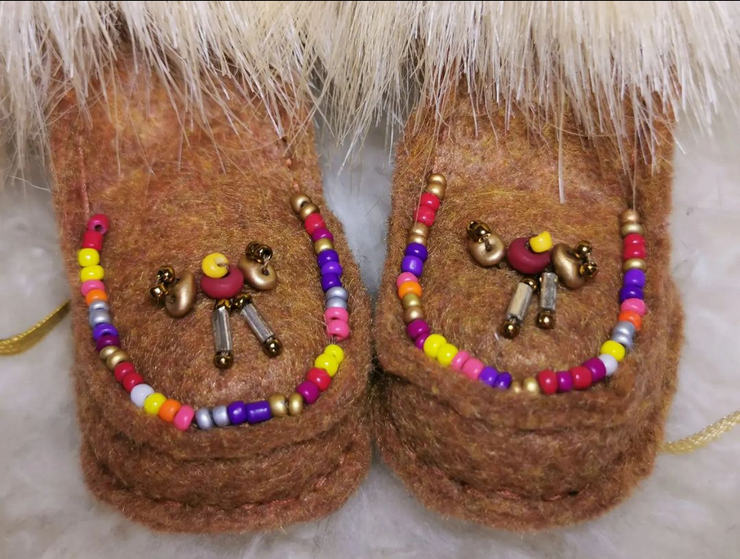 Small matching dancers on brown felt. Hand sewn top stitch with light blond fur. The dancers are small beaded people with hand moving expression.